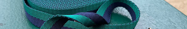 green-and-navy-blue-stripe-training-line-with-brown-leather-trim-on-a-park-bench-in-Paris